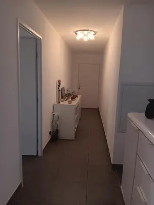 a room with a hallway with a desk and a door at MIRANEO in Miramas