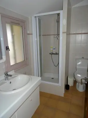 a bathroom with a sink and a shower and a toilet at LES CISTES in Lioux