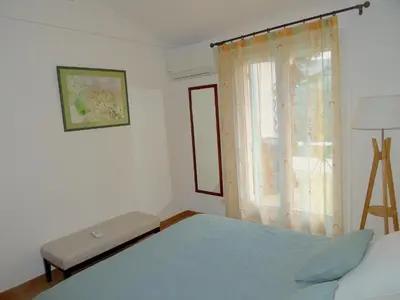 a bedroom with a bed and a window at LES CISTES in Lioux