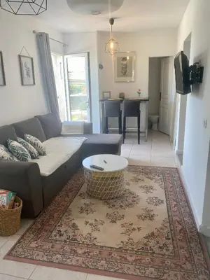 a living room with a couch and a table at Au pied du luberon in Pertuis