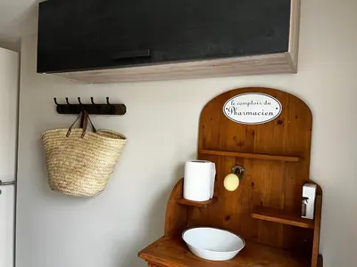 a bathroom with a toilet and a blackboard on the wall at Le capèu in Mollégès