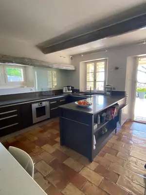 a large kitchen with a island in the middle at La Souvenance - Listed villa in the hills in Lagnes