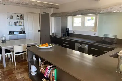 a kitchen with a counter with a bowl of fruit on it at La Souvenance - Listed villa in the hills in Lagnes