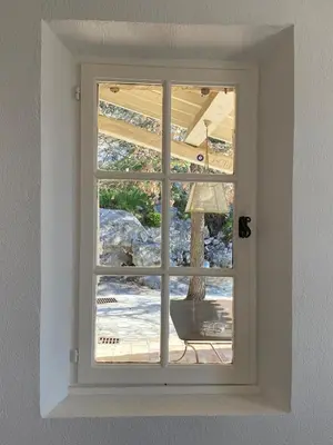 a window with a view of a patio outside at La Souvenance - Listed villa in the hills in Lagnes
