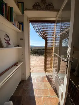 a door leading to a patio with a view at La Souvenance - Listed villa in the hills in Lagnes
