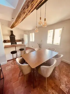 a dining room with a wooden table and chairs at Charmant T2bis coeur historique, Clim, possibilité garage in Aix-en-Provence