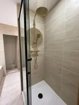 a shower with a glass door in a bathroom at Charmant T2bis coeur historique, Clim, possibilité garage in Aix-en-Provence