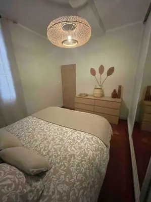 a bedroom with a bed and a chandelier at Charmant T2bis coeur historique, Clim, possibilité garage in Aix-en-Provence