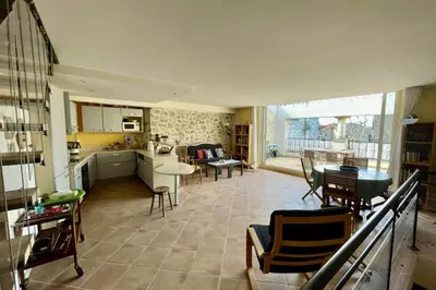 a kitchen and living room with a table and chairs at Village house Stella in Saint-Cannat