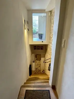 a hallway with a staircase with a window and a window at Village house Stella in Saint-Cannat