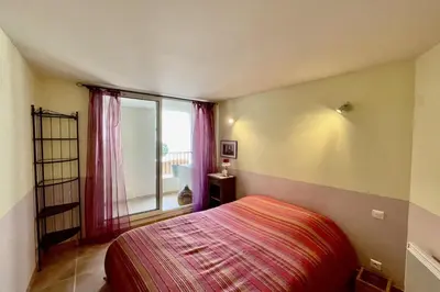 a bedroom with a bed and a large window at Village house Stella in Saint-Cannat