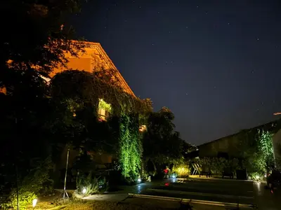 a building with green ivy on it at night at La Cassiopée in Caromb