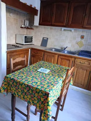 a kitchen with a table with a table cloth on it at Appartement charmant à Aix-en-Provence - 48m² - Balcon privé in Aix-en-Provence