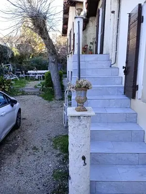 a stone pillar with a vase on it in front of a house at Appartement charmant à Aix-en-Provence - 48m² - Balcon privé in Aix-en-Provence