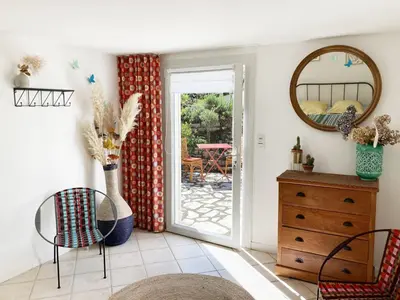 a room with a dresser and a sliding glass door at Les Lavandes in Saignon