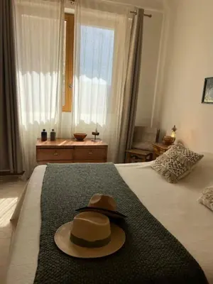 a hat sitting on top of a bed at Luberon en Provence - La maison de Michèle au cœur de Goult in Goult