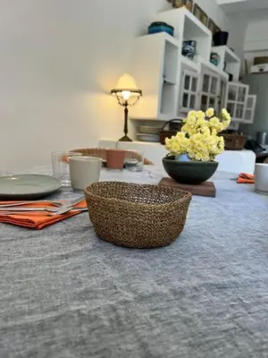 a table with baskets and plates and flowers on it at Luberon en Provence - La maison de Michèle au cœur de Goult in Goult