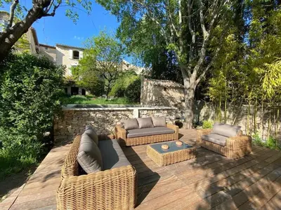 a patio with two couches and a coffee table at Luberon en Provence - La maison de Michèle au cœur de Goult in Goult