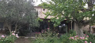 a house with a garden with flowers and trees at Lou Boulugi in Aix-en-Provence