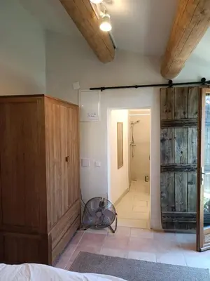 a bedroom with wooden walls and a room with a door at Lou Boulugi in Aix-en-Provence