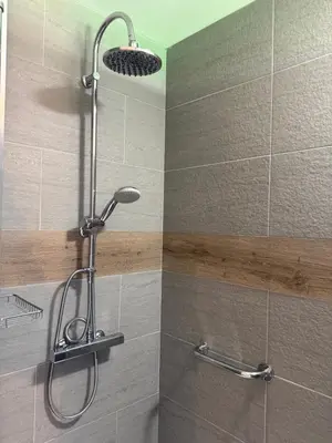 a shower with a shower head in a bathroom at Dépendance au sein d’une villa avec piscine in Aix-en-Provence