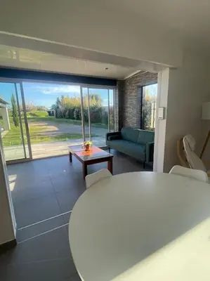 a living room with a couch and a table at Dépendance au sein d’une villa avec piscine in Aix-en-Provence
