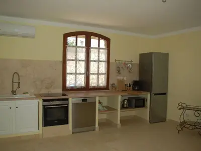 a kitchen with a counter and a refrigerator at Camargue Modern retreat in Cavaillon