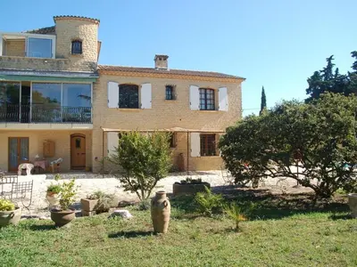 a large house with a garden in front of it at Camargue Modern retreat in Cavaillon