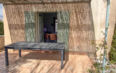 a screened in porch with a table and a mirror at Awesome Home In Saint-Rémy-De-Provence in Saint-Rémy-de-Provence