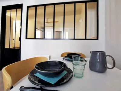 a table with two bowls and plates on it at Confortable et cosy appartement en centre-ville in Aix-en-Provence