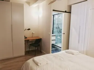 a bedroom with a bed and a desk with a chair at Confortable et cosy appartement en centre-ville in Aix-en-Provence