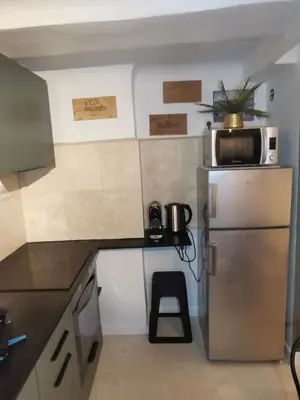 a small kitchen with a microwave and a refrigerator at Appartement centre historique Aix en Provence, Place RAMUS in Aix-en-Provence