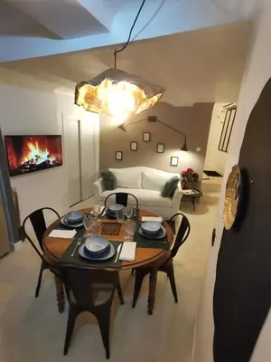 a living room with a table and a couch at Appartement centre historique Aix en Provence, Place RAMUS in Aix-en-Provence