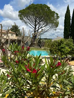 a resort with a swimming pool and flowers at LAVENINE a Modène in Modène