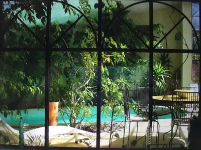 a view of a pool through a window at Ecolodge Au fil de l'eau, avec piscine intérieure et parc arboré in Lagnes