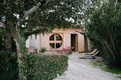 a house with two chairs in front of it at Charming Tiny House in LʼIsle-sur-la-Sorgue