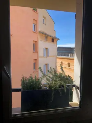 a window with a view of a building at AIX Centre LOFT Duplex Terrasse climatisation wifi in Aix-en-Provence