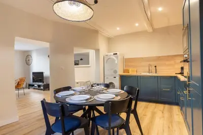 a kitchen and dining room with a table and chairs at Le Triplex - 8 pers - Hypercentre - Wifi in LʼIsle-sur-la-Sorgue