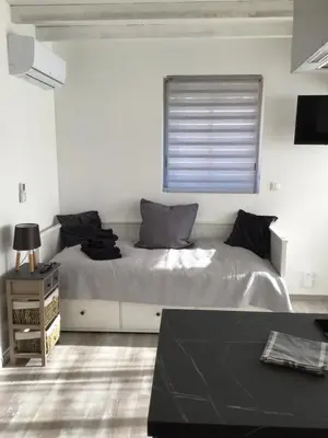 a bedroom with a large bed with a window at La maison Anaïa in Gargas