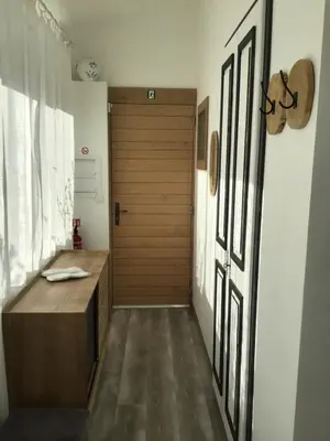 a hallway with a wooden door in a room at La maison Anaïa in Gargas