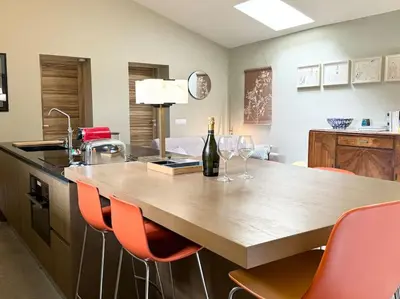 a living room with a table and a couch at Loft en campagne proche de l’Isle sur Sorgue in Le Thor