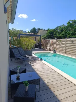 a swimming pool with chairs and a table next to it at La Cigale sous l'Olivier - Chambre , SdB et Salon Privé - Piscine in Les Taillades