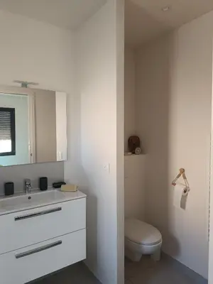 a bedroom with a blue bed with towels on it at La Cigale sous l'Olivier - Chambre , SdB et Salon Privé - Piscine in Les Taillades