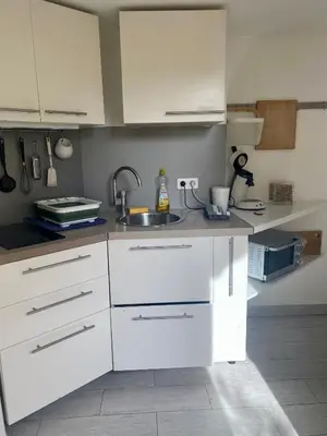 a kitchen with white cabinets and a sink at A 20 minutes de Aix en Provence in Pertuis