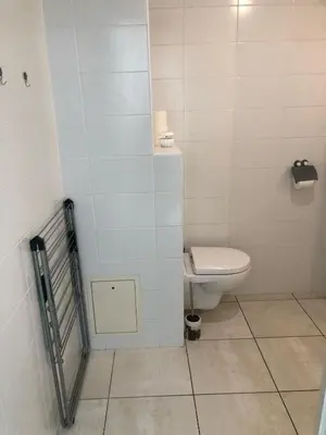 a bathroom with a toilet and a tiled floor at ITER House \uc774\ud130 \ud558\uc6b0\uc2a4 in Aix-en-Provence