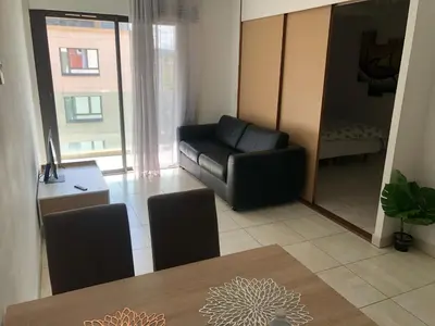 a living room with a black leather couch and a table at ITER House \uc774\ud130 \ud558\uc6b0\uc2a4 in Aix-en-Provence