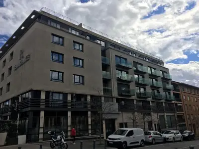 a large building with cars parked in front of it at ITER House \uc774\ud130 \ud558\uc6b0\uc2a4 in Aix-en-Provence