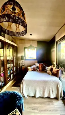 a bedroom with a large bed and a chandelier at Nouveau ENVOUTEMENT près de GORDES Provence Maison entière neuve archi luxe écolo 4 pers parking privé in Robion en Luberon