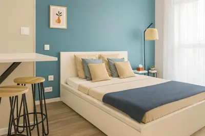 a bedroom with a large bed with blue walls at 014 Studio Provençal - Proche d'Aix en Provence in Éguilles