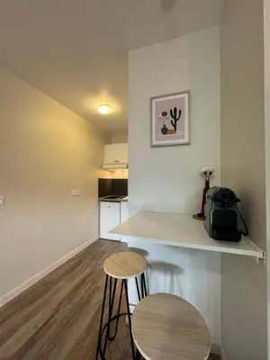 a small kitchen with a counter and two stools at 014 Studio Provençal - Proche d'Aix en Provence in Éguilles